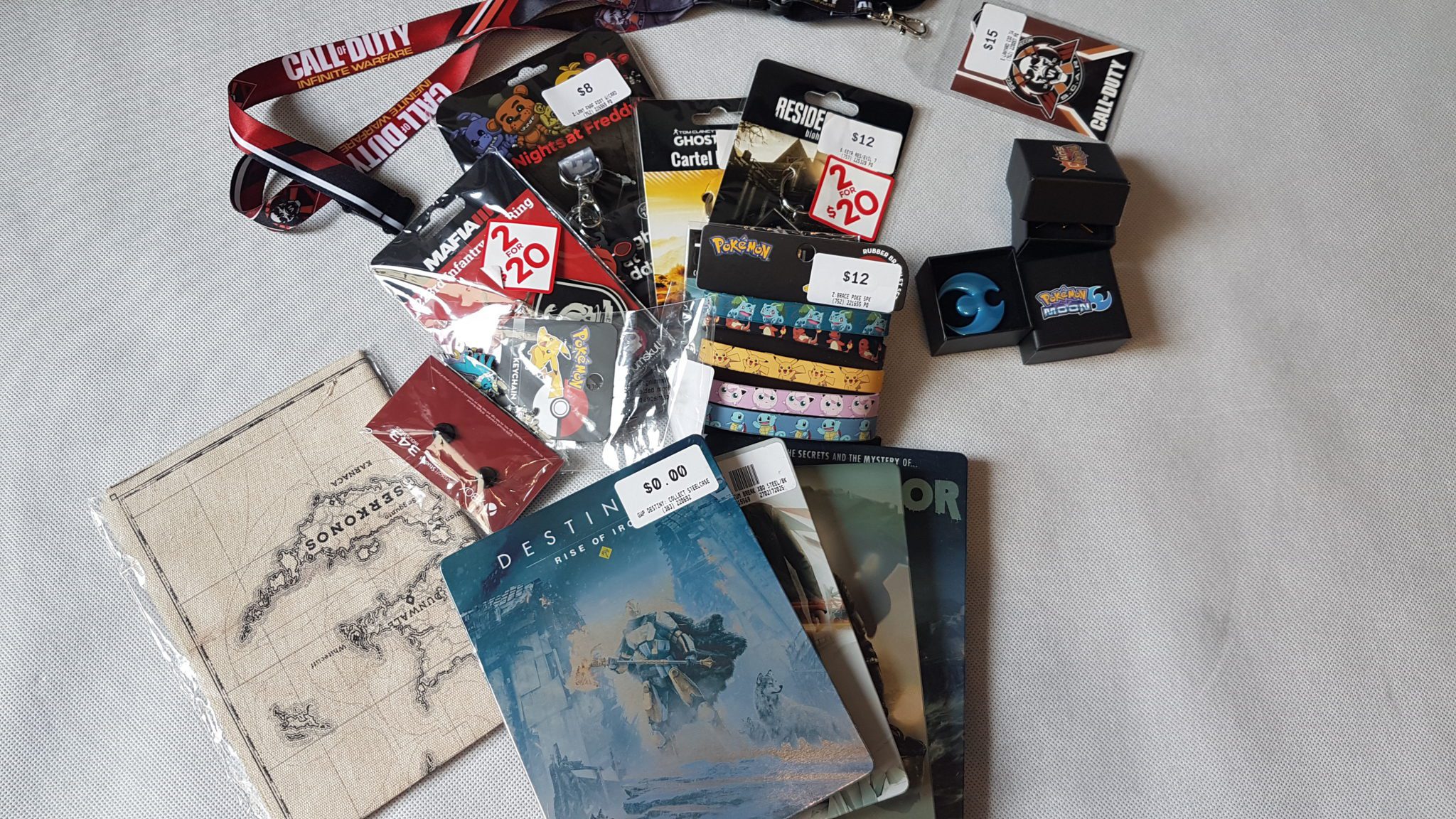 EB Games Australia – Gadżety – Steelbook, Smycze, Breloki